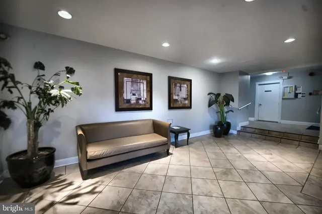 a living room with furniture and flowers