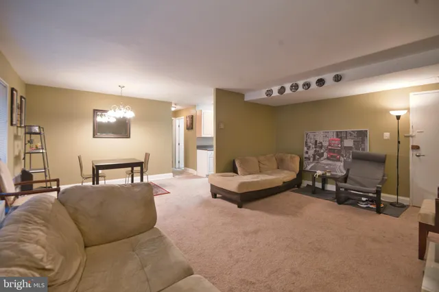 a living room with furniture gym equipment and a large mirror