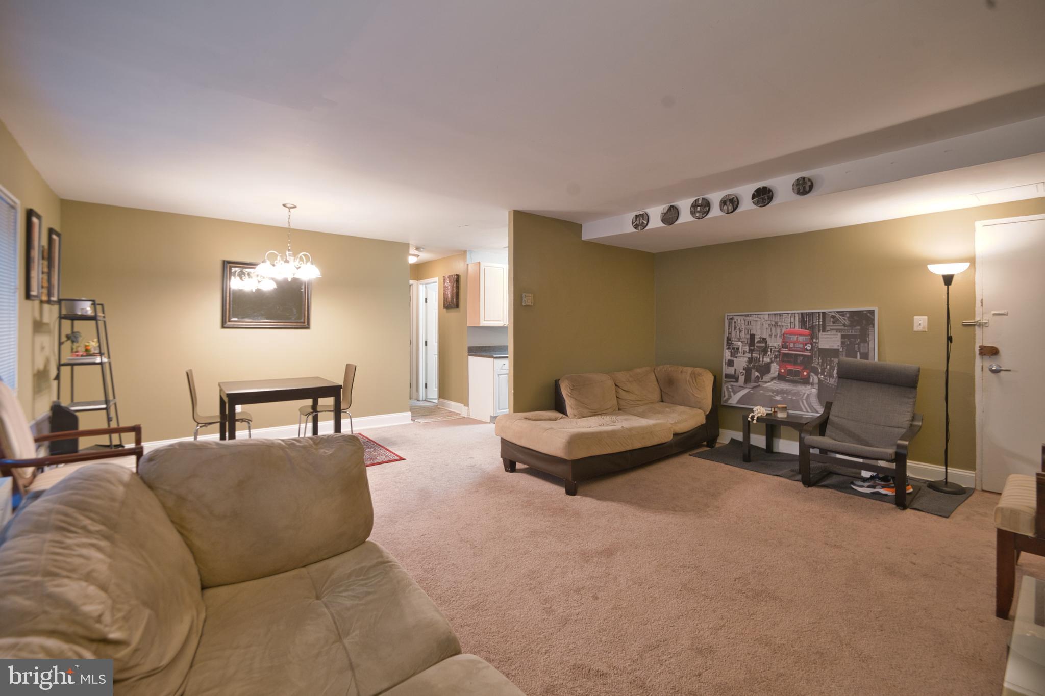 1005 Chillum Road, Unit 117 Hyattsville, MD 20782 - Photo 5 of 16 a living room with furniture gym equipment and a large mirror