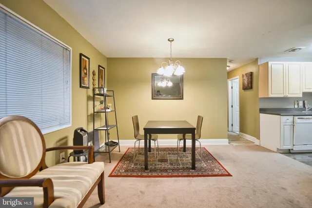 a dining room with furniture and chandelier
