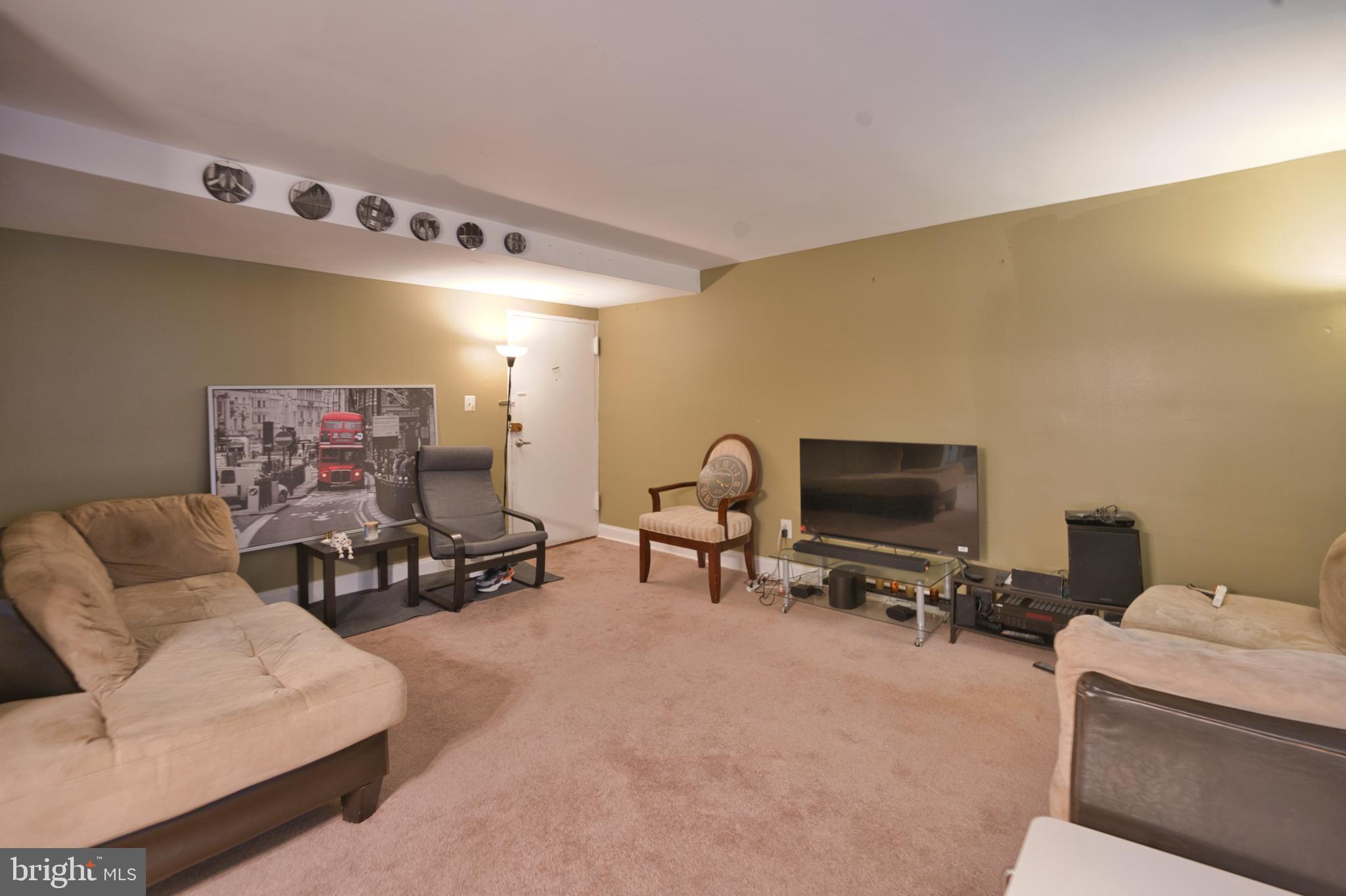 1005 Chillum Road, Unit 117 Hyattsville, MD 20782 - Photo 7 of 16 a living room with furniture and a flat screen tv