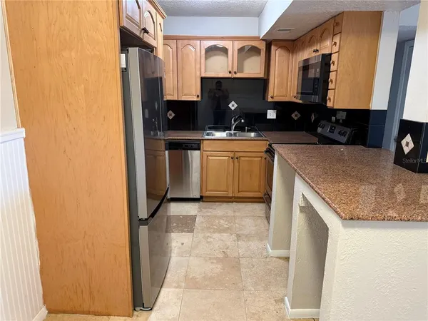 a kitchen with a sink a stove and cabinets