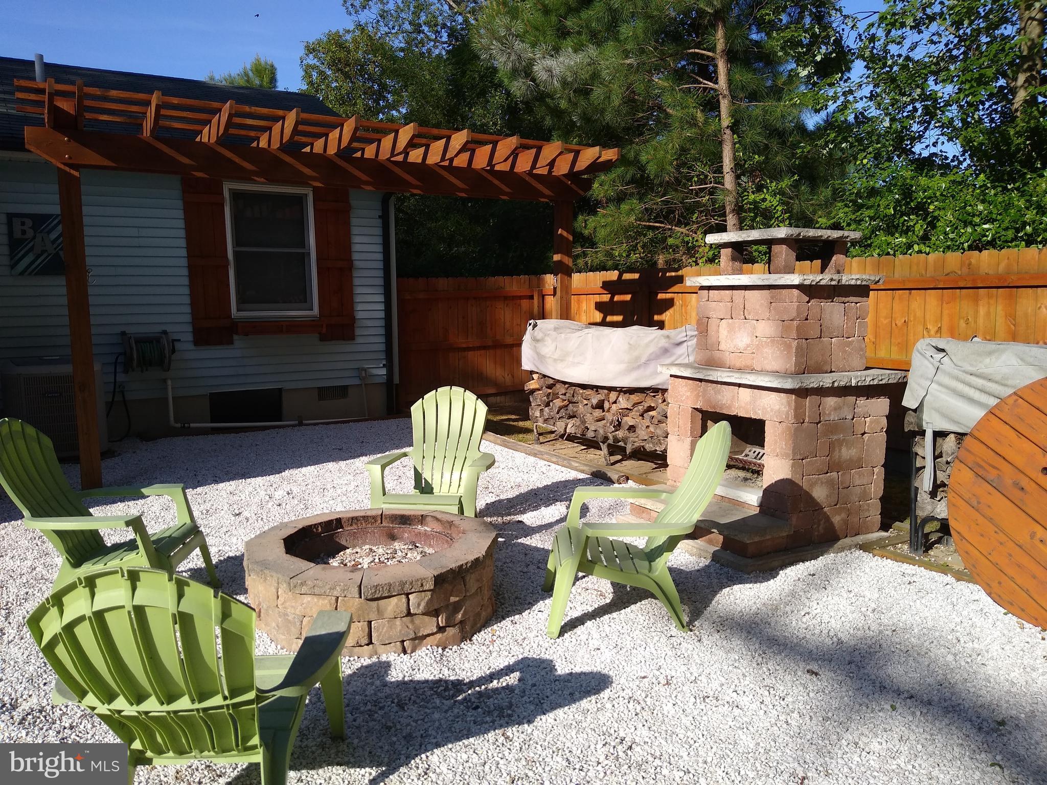 Sitting area around fire pit and outdoor fireplace
