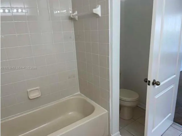 a bathroom with a bathtub and a toilet