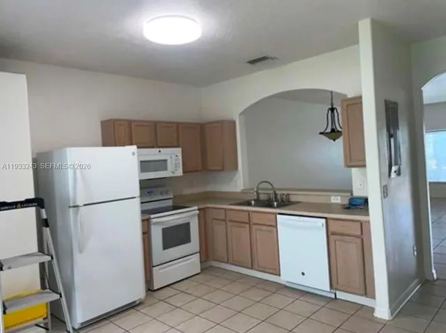 a white refrigerator freezer sitting inside of a kitchen