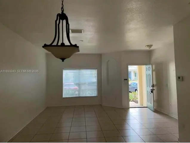 a view of a hallway with a chandelier