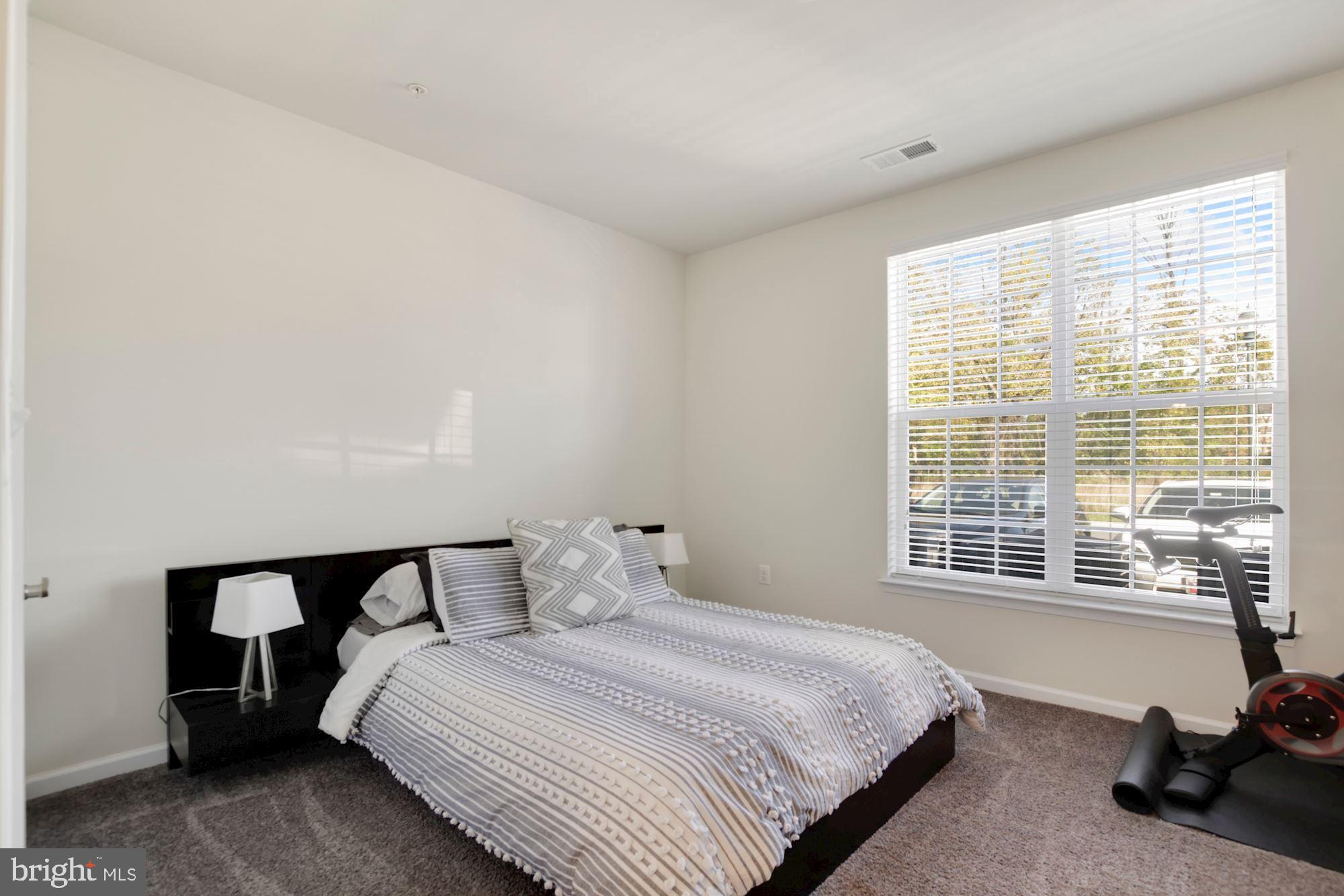 3825 Doc Berlin Drive, Unit 17 Silver Spring, MD 20906 - Photo 15 of 34 a bedroom with a bed a table and a window