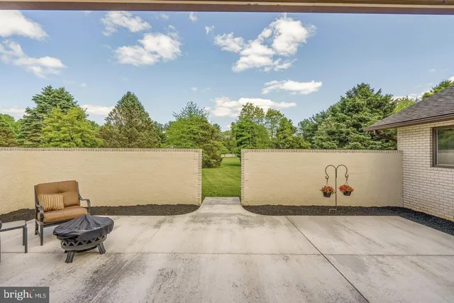 a view of a patio with table and chairs with wooden floor and fence