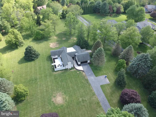 an aerial view of a house with a yard