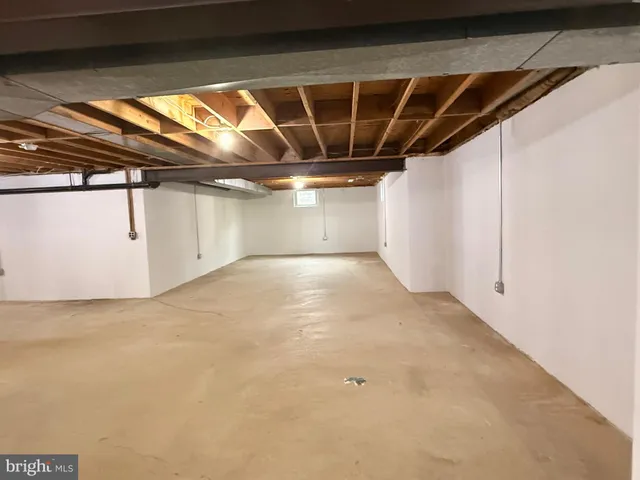 a view of a hallway with wooden floor and chandelier