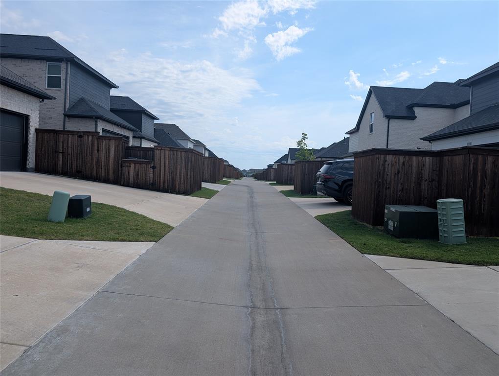 15532 Fringe Tree Road Frisco, TX 75035 - Photo 20 of 31 Concrete driveways and walkways, manicured turf, and privacy fencing