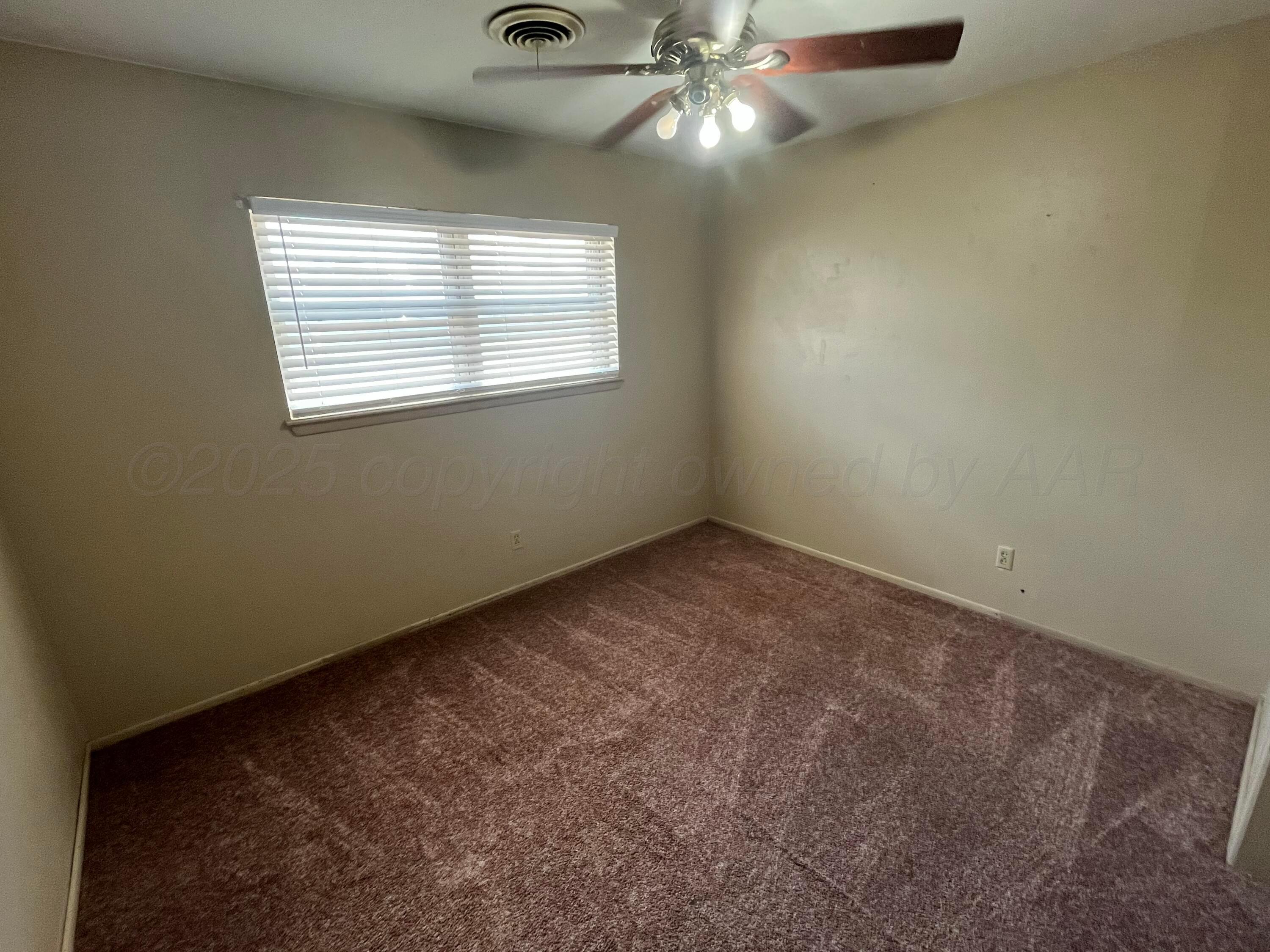 604 West Oak Street Dimmitt, TX 79027 - Photo 26 of 26 an empty room with windows and fan