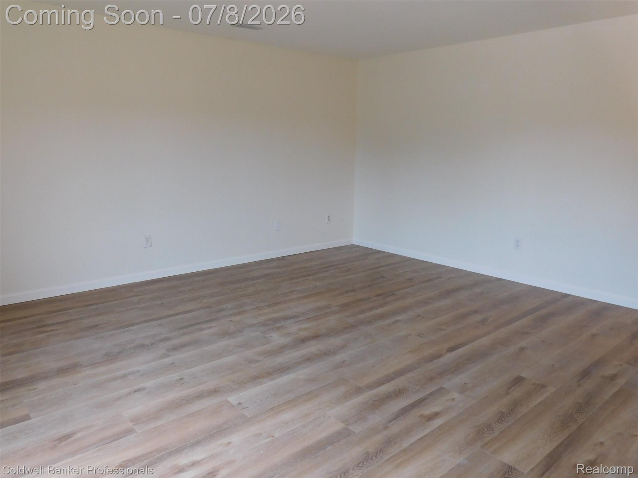 284 East 13 Mile Road Madison Heights, MI 48071 - Photo 8 of 21 Expansive room featuring wood-finish flooring, light-toned walls, and white baseboards