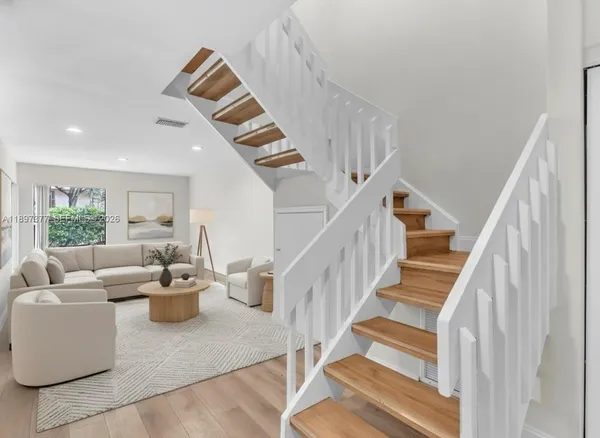 a living room with furniture fireplace and a large window