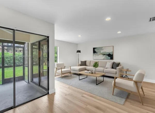 a view of a livingroom with furniture and wooden floor