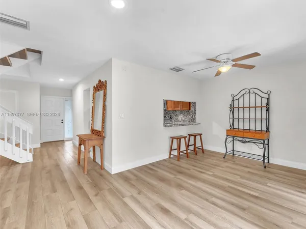 a view of a hall with wooden floor