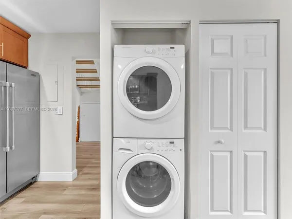 a view of a hallway with washer and dryer