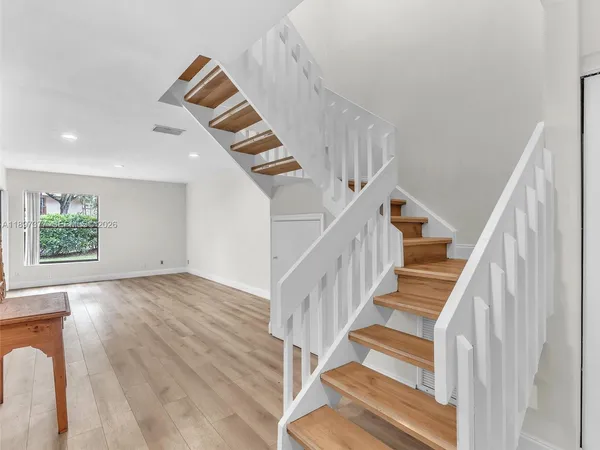 a view of entryway with wooden floor