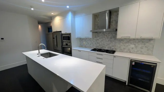 a kitchen with a sink a stove and cabinets