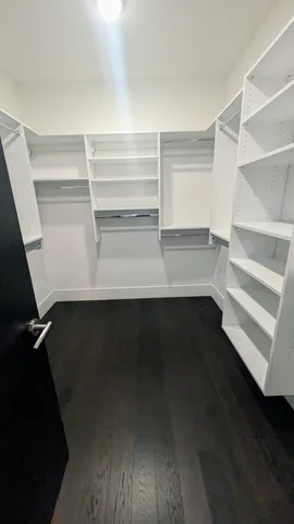 a view of walk in closet with empty racks