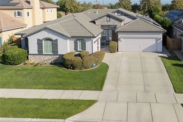 a front view of a house with a garden and plants