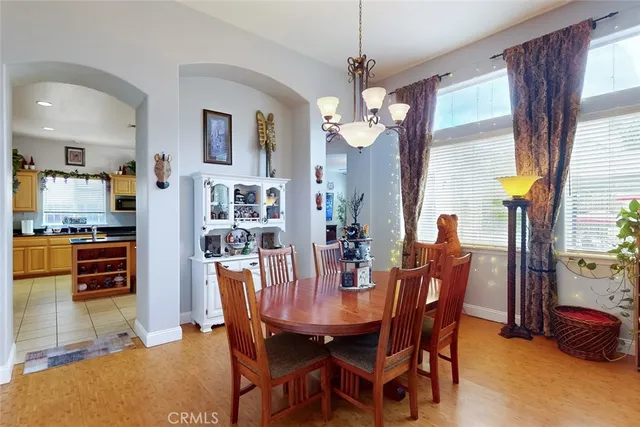 a view of a dining room with furniture and a chandelier