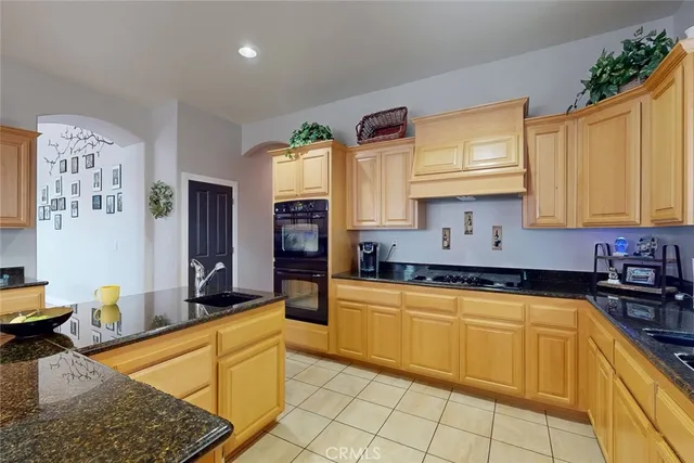 a kitchen with stainless steel appliances granite countertop a sink and cabinets
