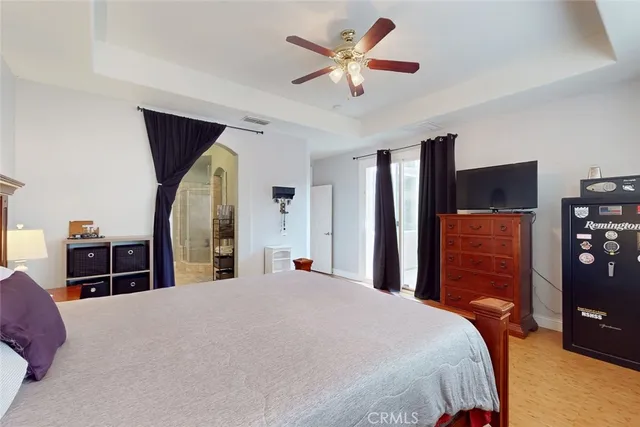 a bedroom with a large bed and a chandelier