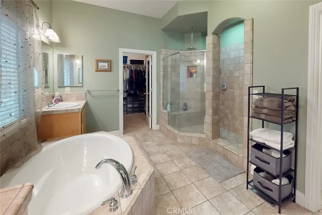 a spacious bathroom with a tub shower and checkered floor