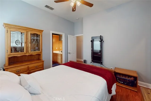 a bedroom with a large bed and a chandelier