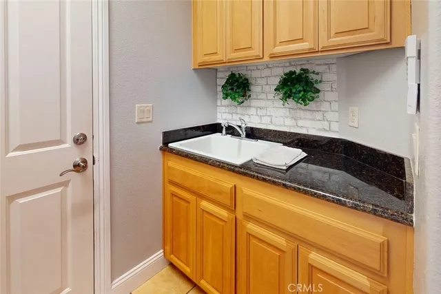 a bathroom with a granite countertop sink and vanity