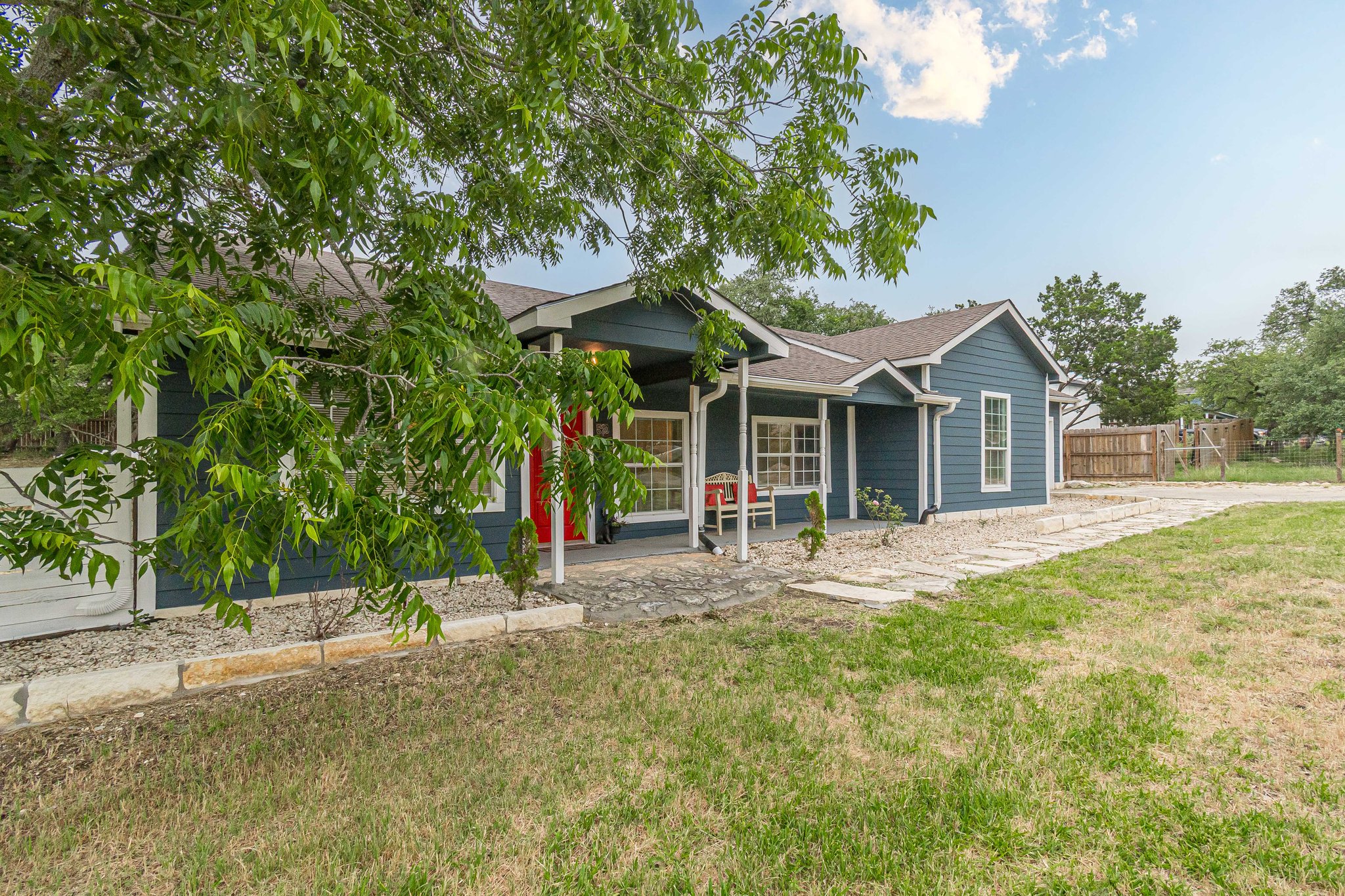 560 Persimmon Pass Fischer, TX 78623 - Photo 2 of 26 a front view of a house with a yard and trees