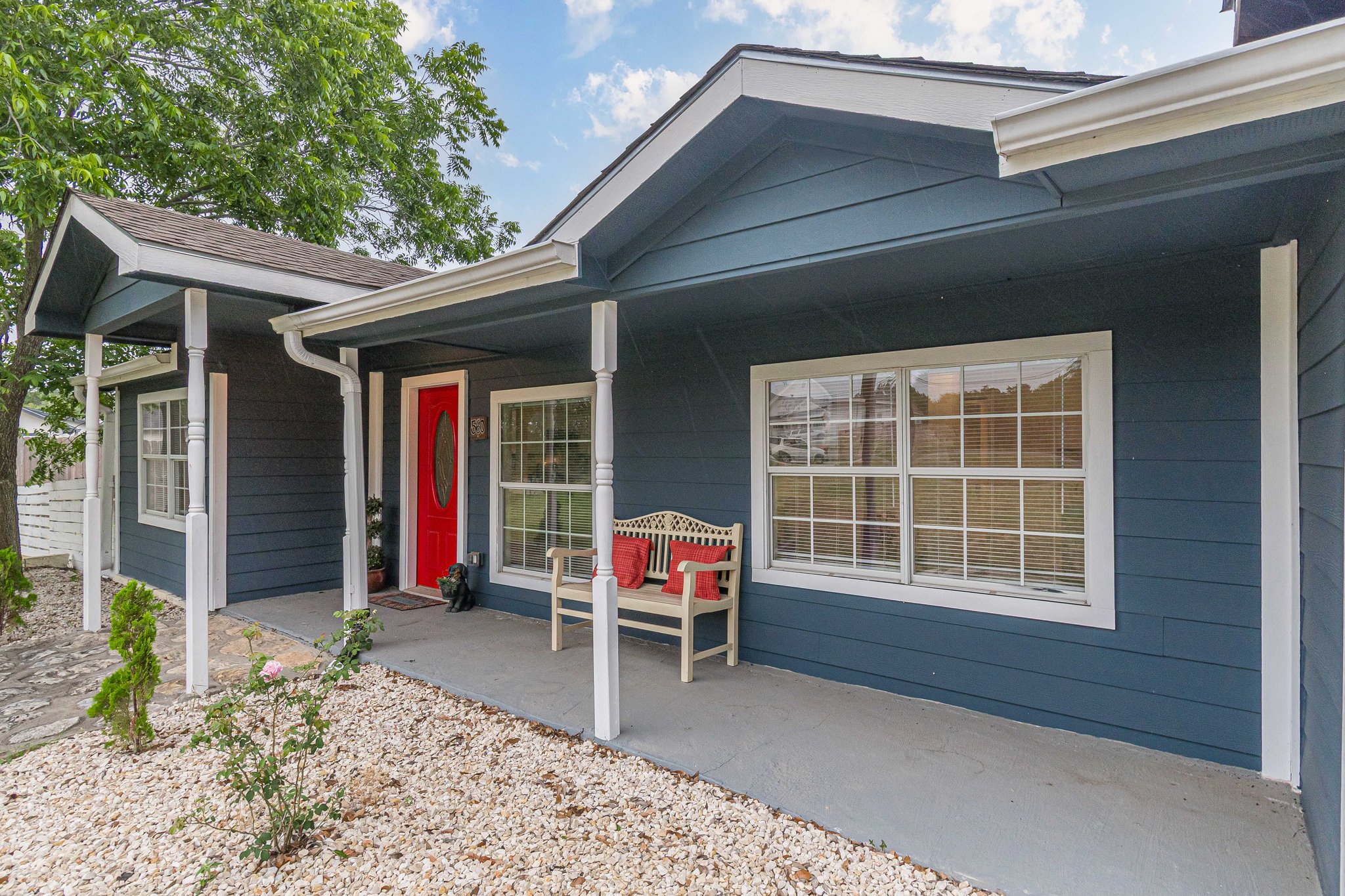 560 Persimmon Pass Fischer, TX 78623 - Photo 3 of 26 a chair and table in front of a house