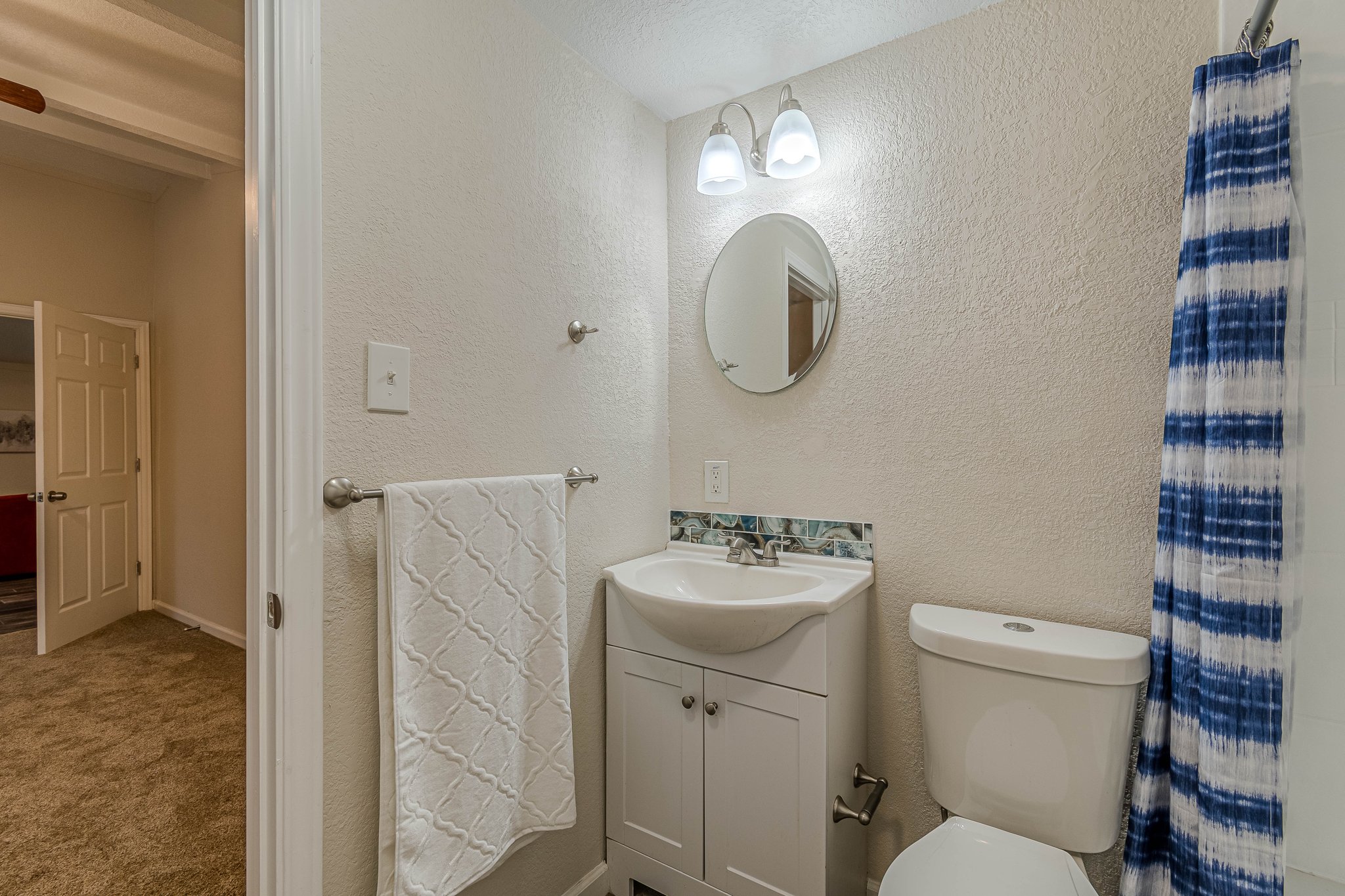 560 Persimmon Pass Fischer, TX 78623 - Photo 7 of 26 a bathroom with a toilet a sink and a mirror