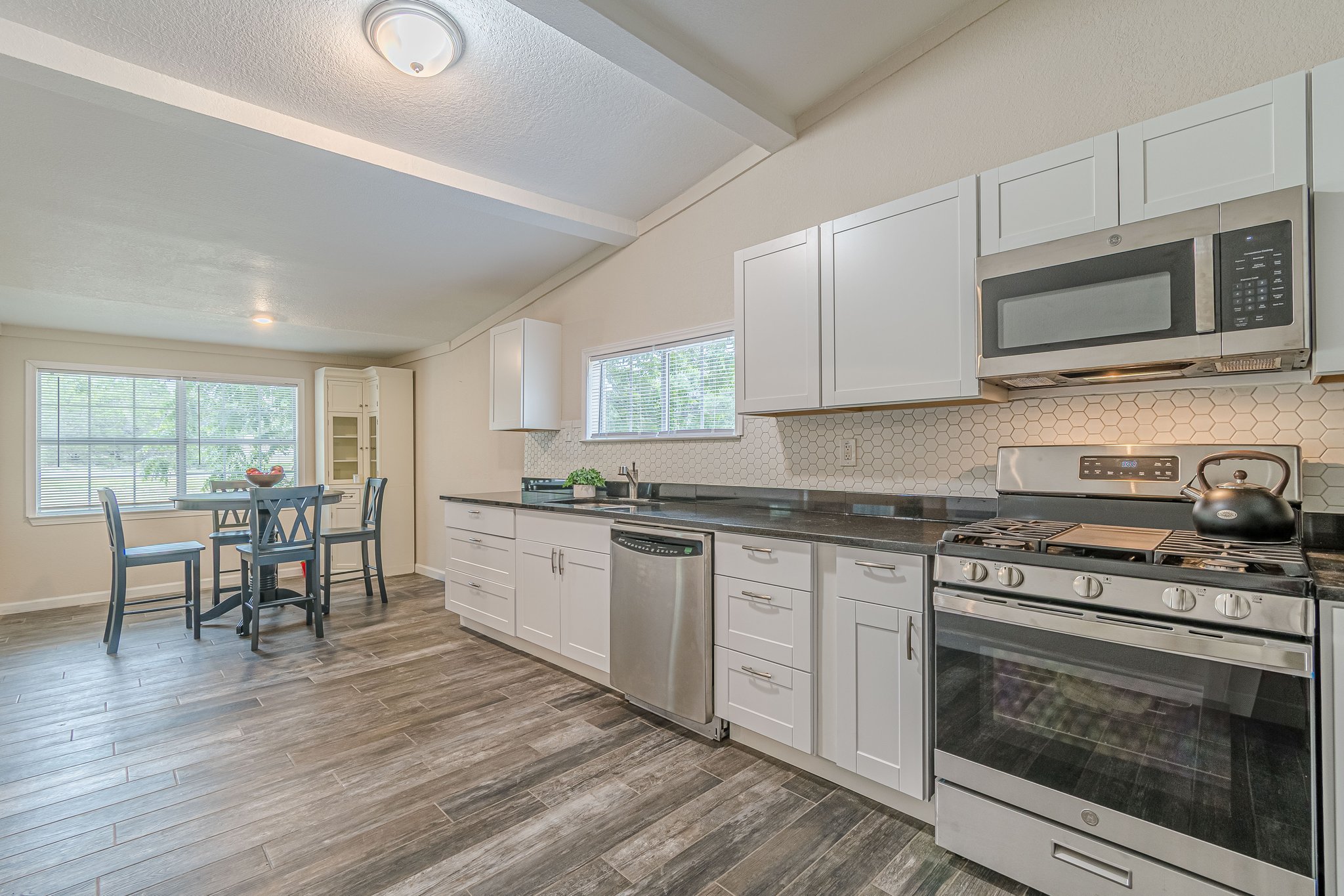 560 Persimmon Pass Fischer, TX 78623 - Photo 10 of 26 a kitchen with stainless steel appliances wooden floors and wooden cabinets