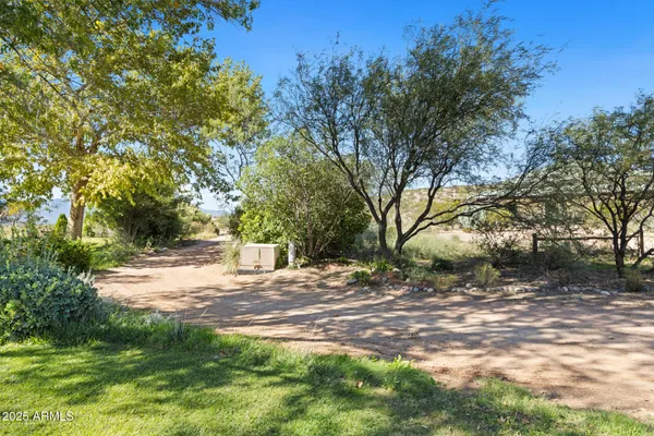 a view of backyard of house with green space