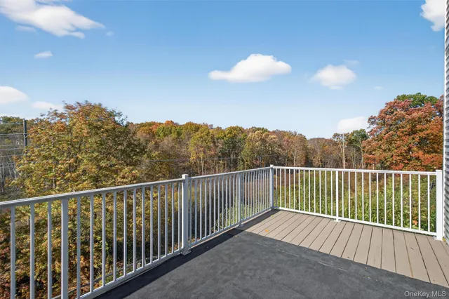 an empty room with wooden floor a fireplace and windows