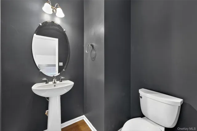 a kitchen with stainless steel appliances granite countertop a refrigerator a stove and a sink with wooden floor