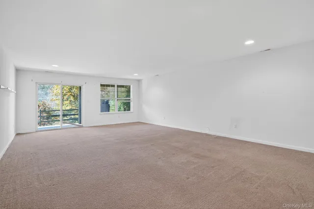 a view of an empty room and closet area