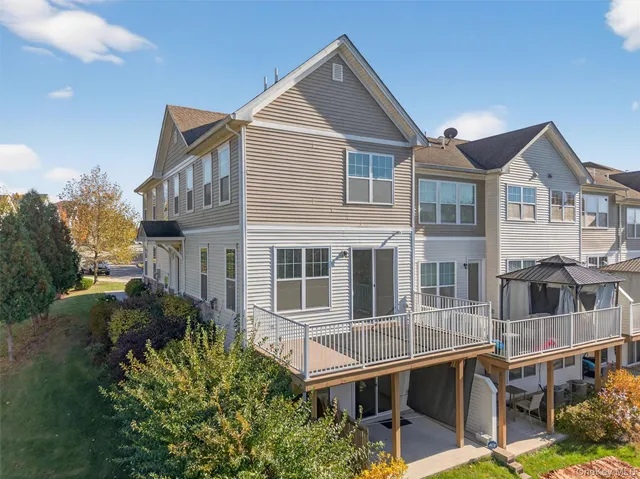 a aerial view of a house with a yard balcony and seating space