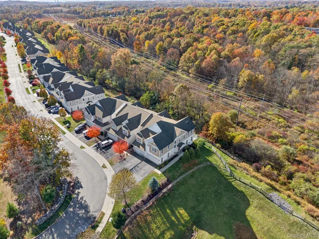 an aerial view of residential building and lake