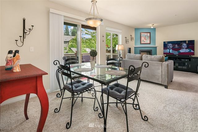 a dining room with furniture a chandelier and window