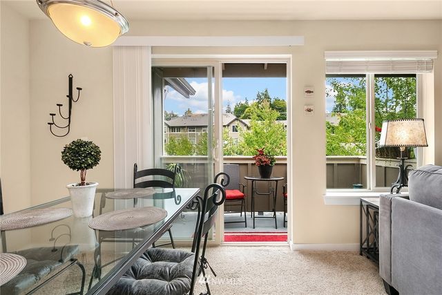 a living room with furniture a rug and a large window