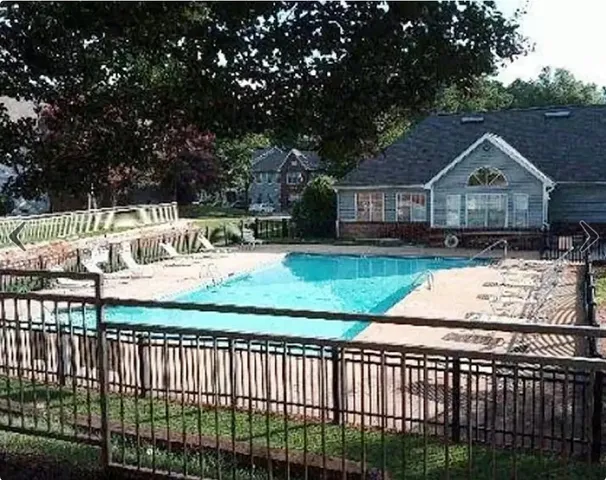 a view of a house with wooden fence