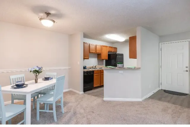 a kitchen with a table and chairs in it