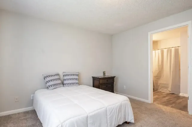 a bedroom with a bed and window