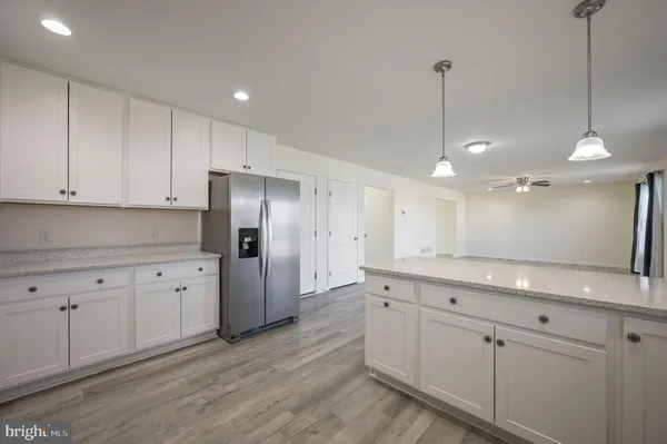 a kitchen with a refrigerator sink and cabinets