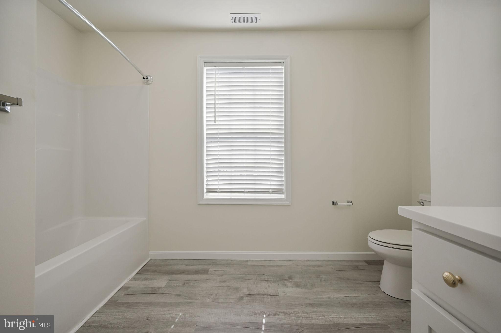 57 Sisal Way Magnolia, DE 19962 - Photo 27 of 30 a bathroom with a toilet and a bathtub