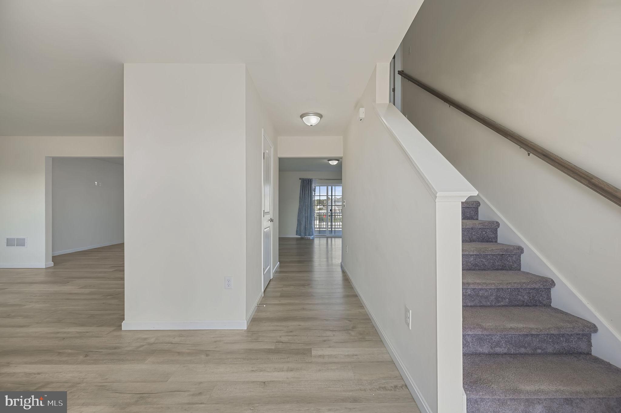 57 Sisal Way Magnolia, DE 19962 - Photo 5 of 30 a view of a hallway with wooden floor and staircase