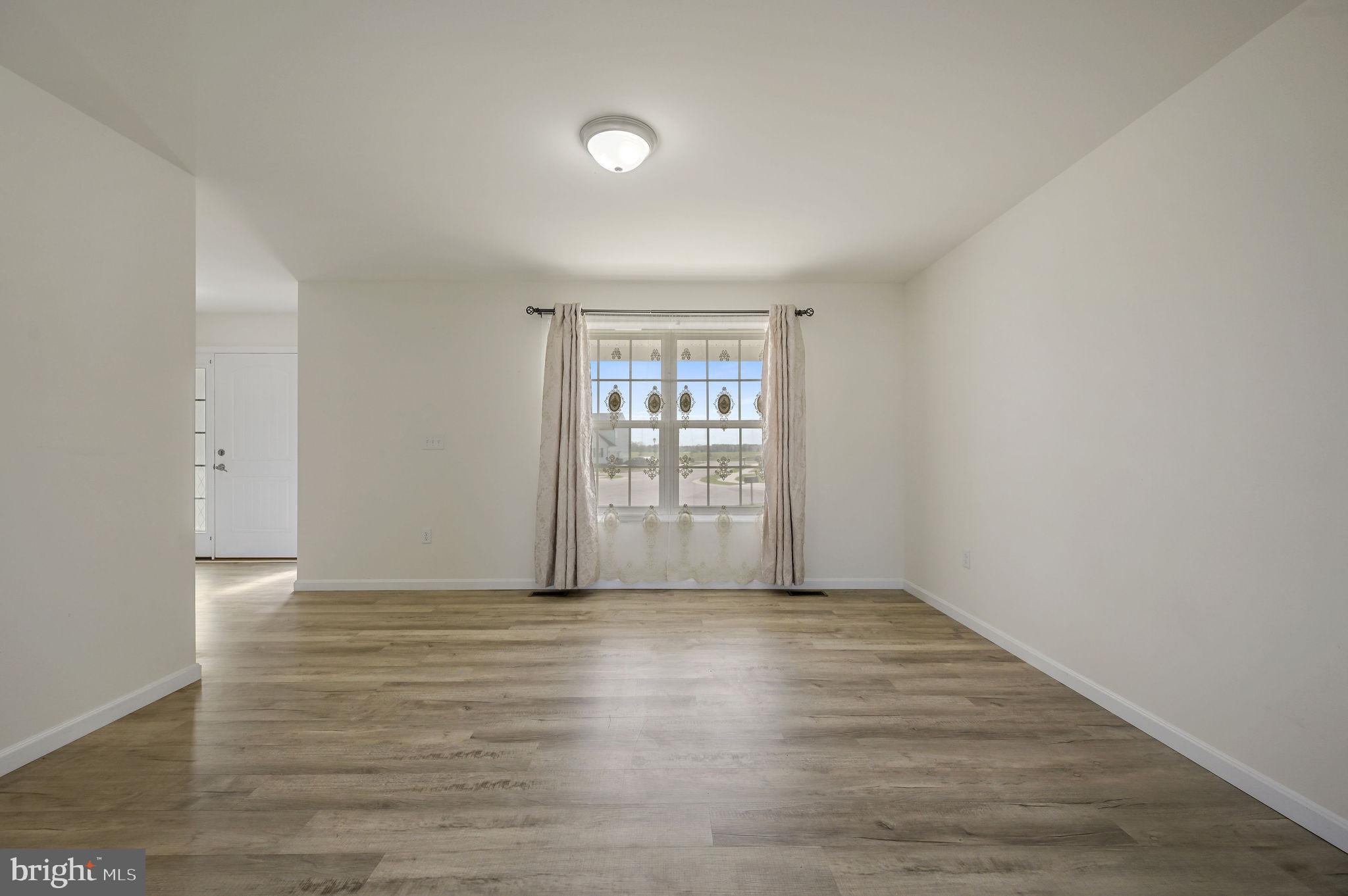 57 Sisal Way Magnolia, DE 19962 - Photo 8 of 30 a view of an empty room with wooden floor and a window